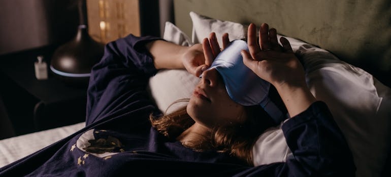 Woman lying in bed and having sleep troubles.