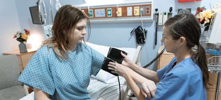 Nurse measuring a patient's blood pressure showing how nurses and doctors provide medical detox support.