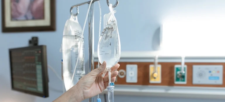 Nurse checking an IV bag.
