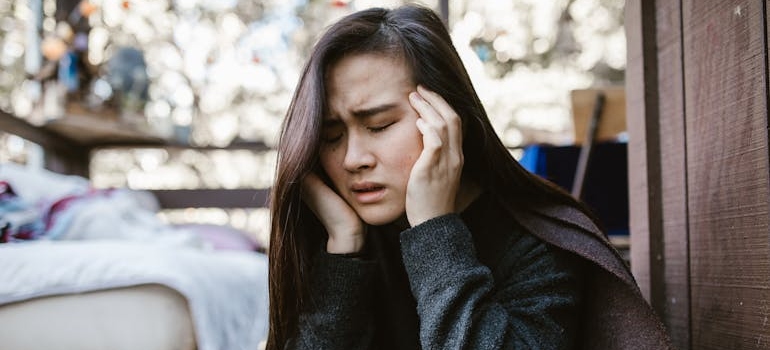 Woman having a headache and rubbing her temples.