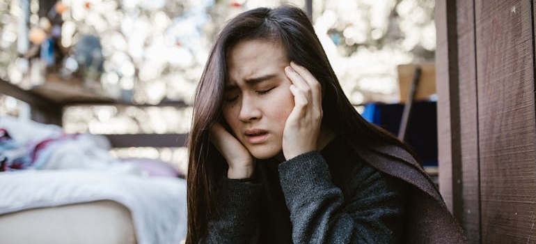 Stressed out woman rubbing her temples.