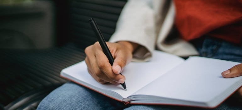 Person journaling in their notebook.