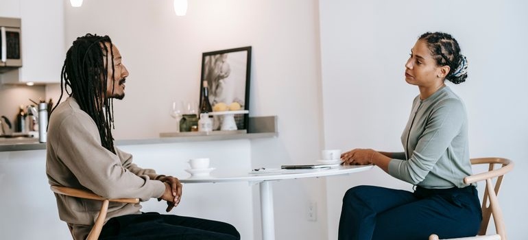 Couple sitting at a table and having a serious conversation.
