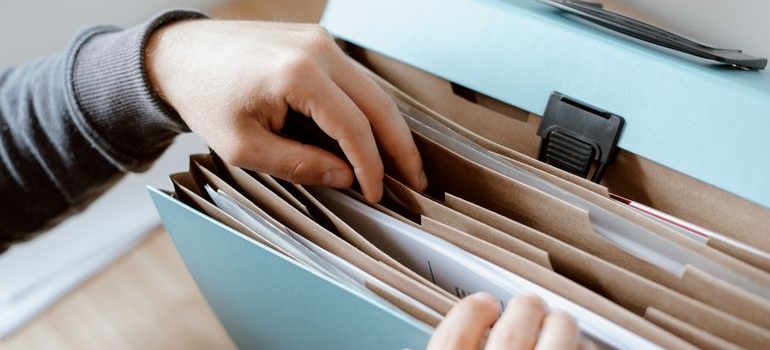 Man looking through a folder of documents.
