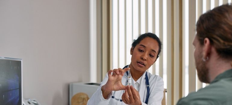 Doctor talking about ketamine therapy for addiction treatment with a patient.