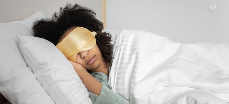 Woman sleeping with a sleep mask.