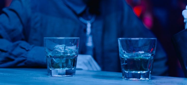 Man sitting at a bar and drinking whiskey.