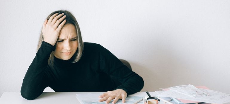 Woman looking at bills and worrying.