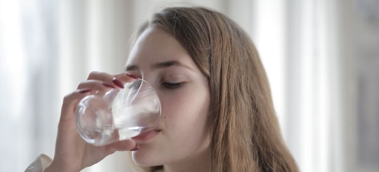 Woman drinking a glass of water.