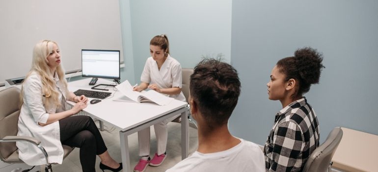 Couple talking with a doctor and a nurse.