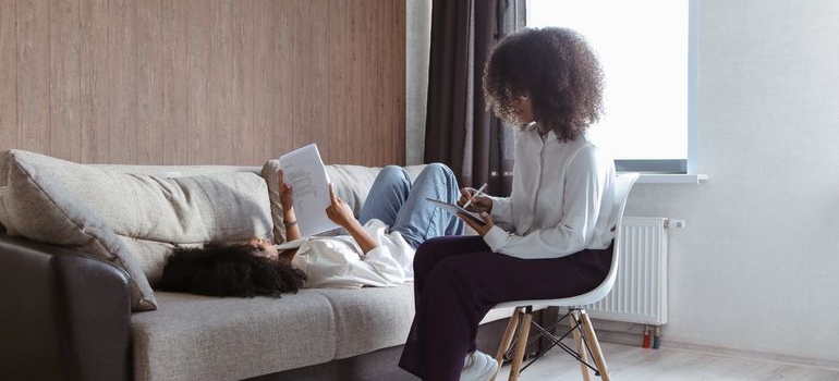 Patient looking at a sheet while talking with a therapist.