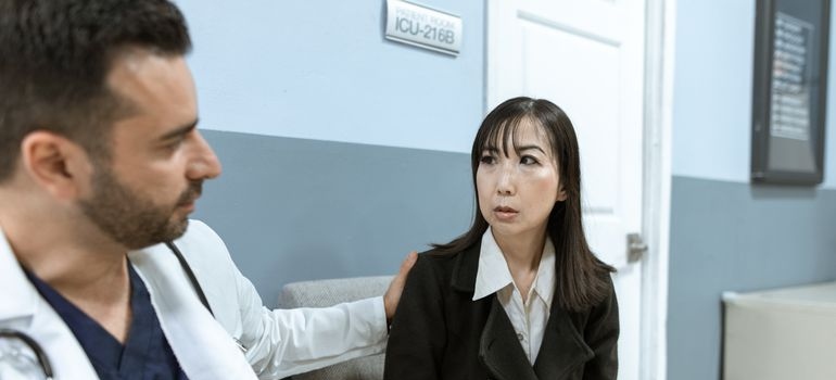 Doctor comforting a patient after getting a wet brain diagnosis.