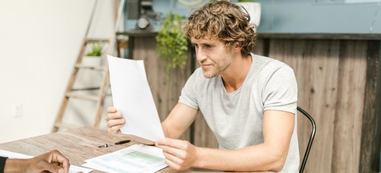 Man reading his explanation of benefits documents.