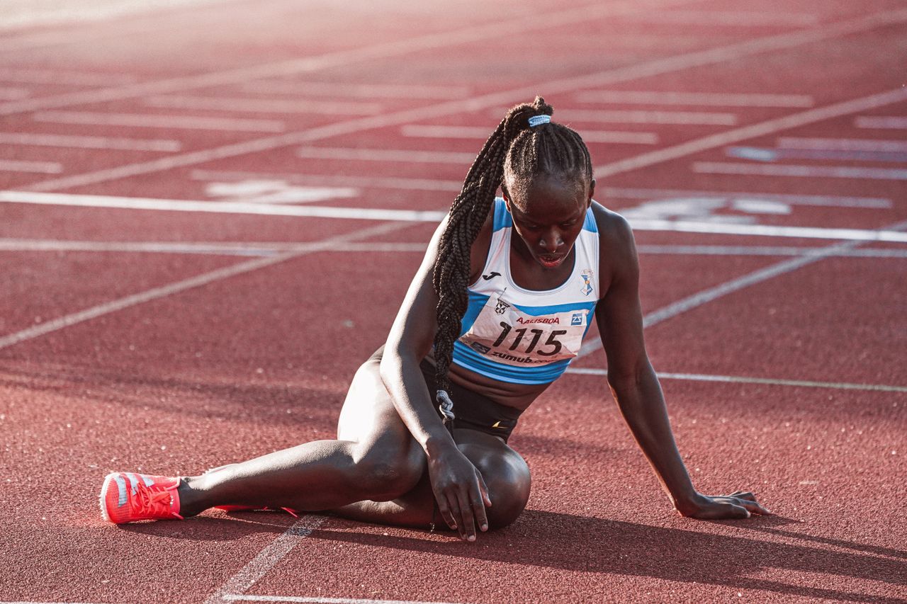 Woman sitting on the running track.