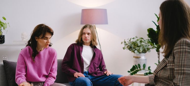 Couple talking about helping vs enabling with their therapist.