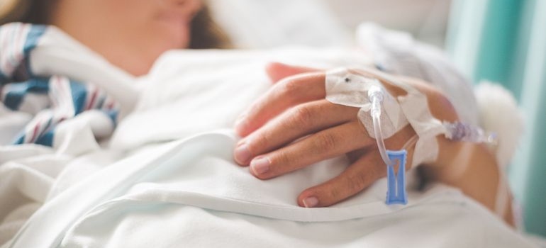 Woman with an IV in her hand being treated for alcohol ketoacidosis.