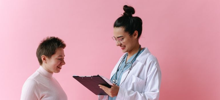 Doctor talking about ketamine therapy for addiction treatment with a patient.