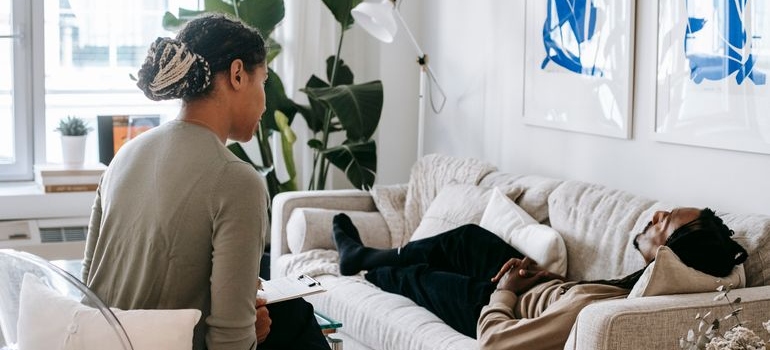 Therapist talking about intermittent sobriety with a client who is lying on the couch.