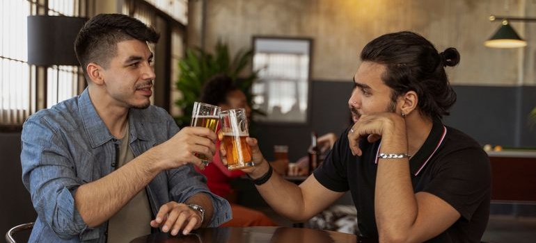 Two men drinking beer together.