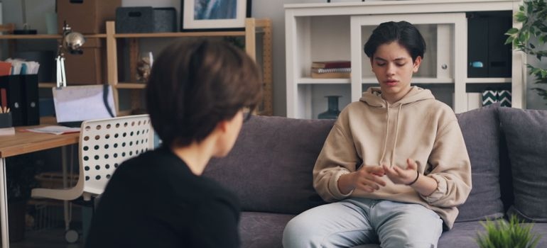 Therapist and a teenage patient talking about consequences of teen drug abuse.